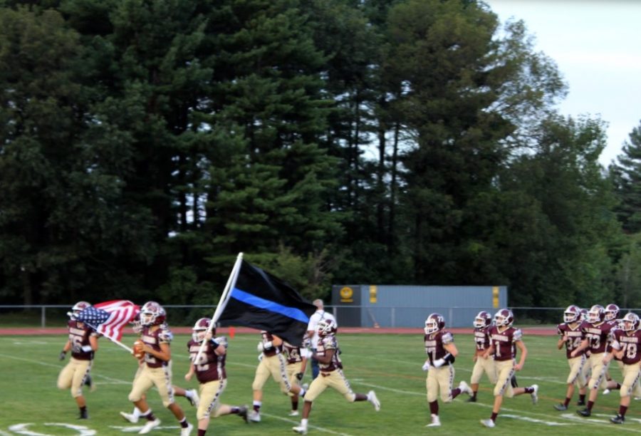 The team storms the field to kick off their home opener against Worcester North on September 7. The T-Hawks won 32-0.