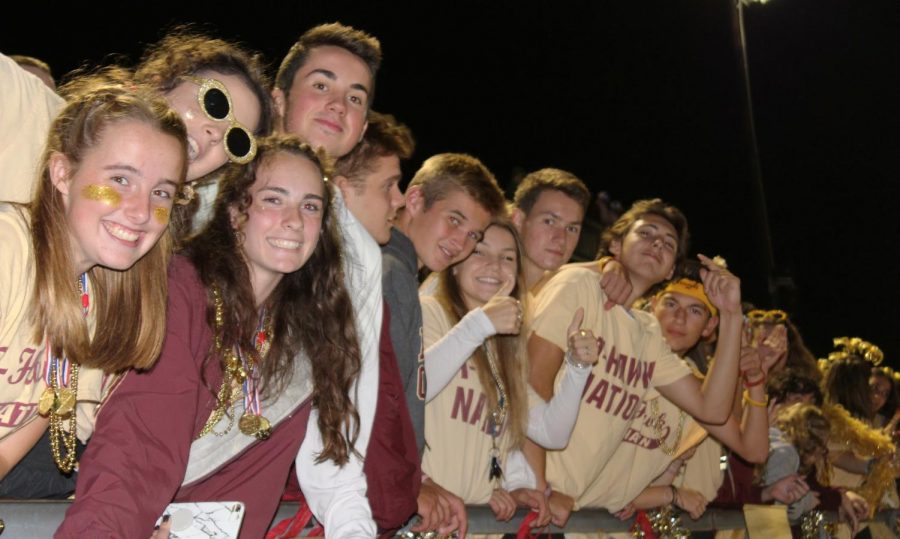 Seniors [from left to right] Laura Dunderdale, Grace Austvold, Grace Rousseau, Evan Scott, James Jessup, Callen Willwerth, Taylor Fenerty, Sean Cullen, Garret Hodgkins and Jonny Symons stand at the front cheering on the T-Hawks. 