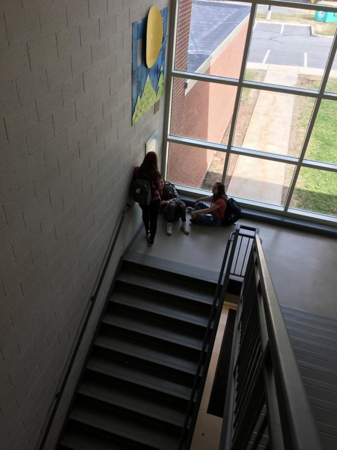 A group of sophomore girls, Sophia Cavallo, Ainslee Rice and Caroline Boudreau, chat in the D200 stairwell after school.