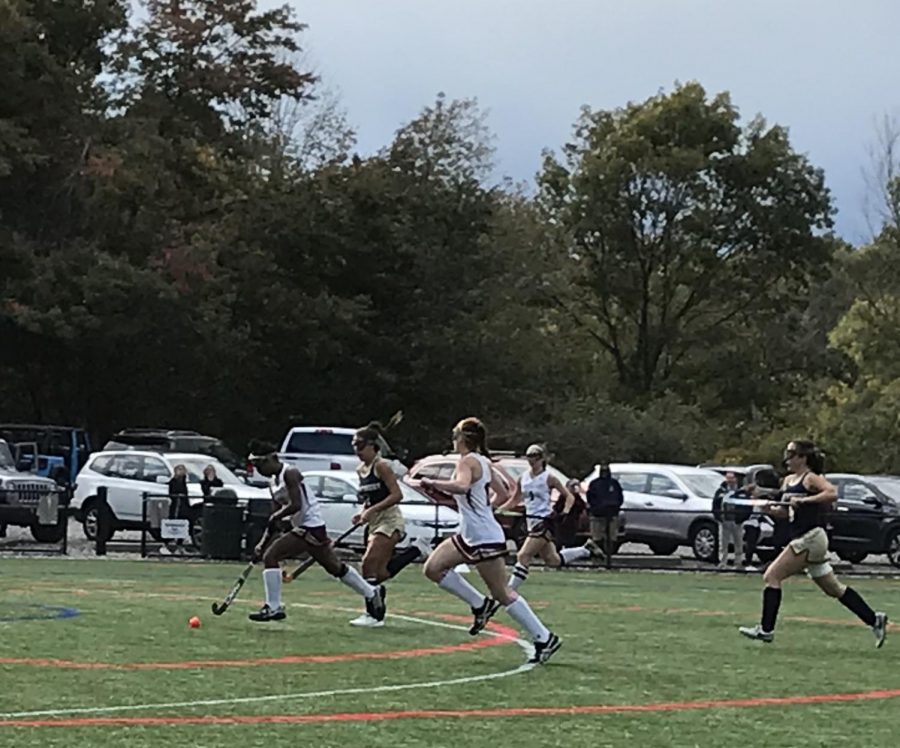 Sophomore Day Ruffo [left]  drives past her opponents, scoring her first goal. 