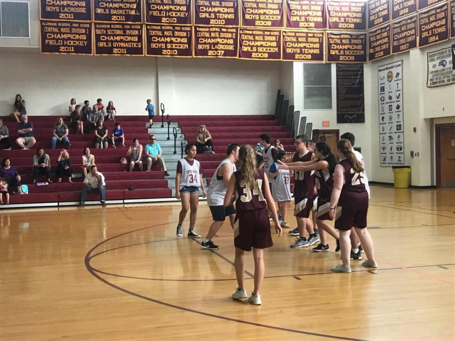 +The+Algonquin+unified+basketball+team+in+white+tries+to+score+a+basket+against+tough+defense+by+Shepherd+Hill.