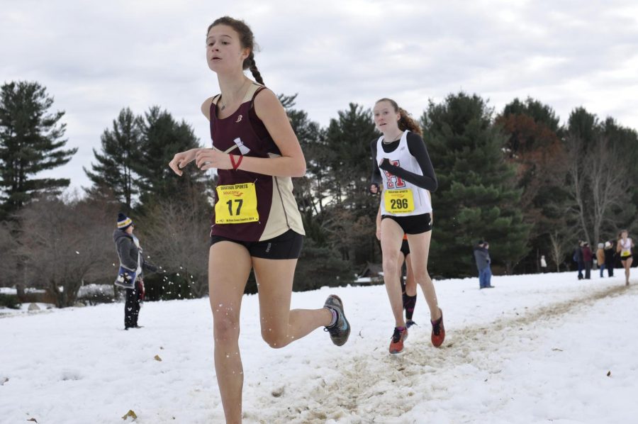 Junior Julia Kardos  runs past her opponent on the snowy trail at Stanley Park for the All-State meet on November 18.