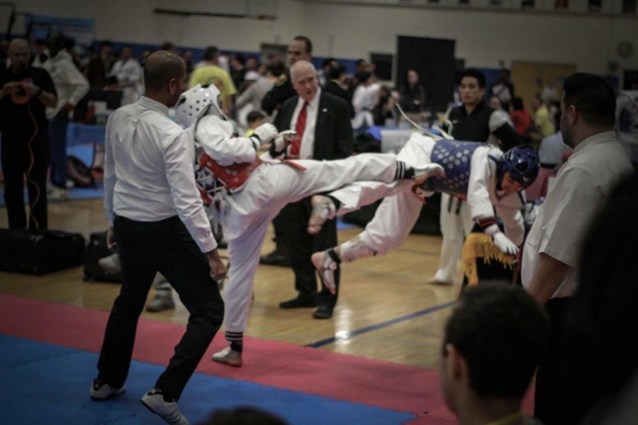 Junior Estevan Zeferino kicks his opponent out of the ring in his second round fight at the Massachusetts State Qualifiers.  He went on to win first place at this event, making him eligible to compete at the National Championship.