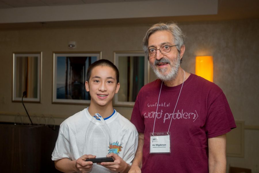 Andrew Lee holds his award proudly with Avi Wigderson from the Institute for Advanced Study at the 2018 Who Wants to be a Mathematician awards breakfast.