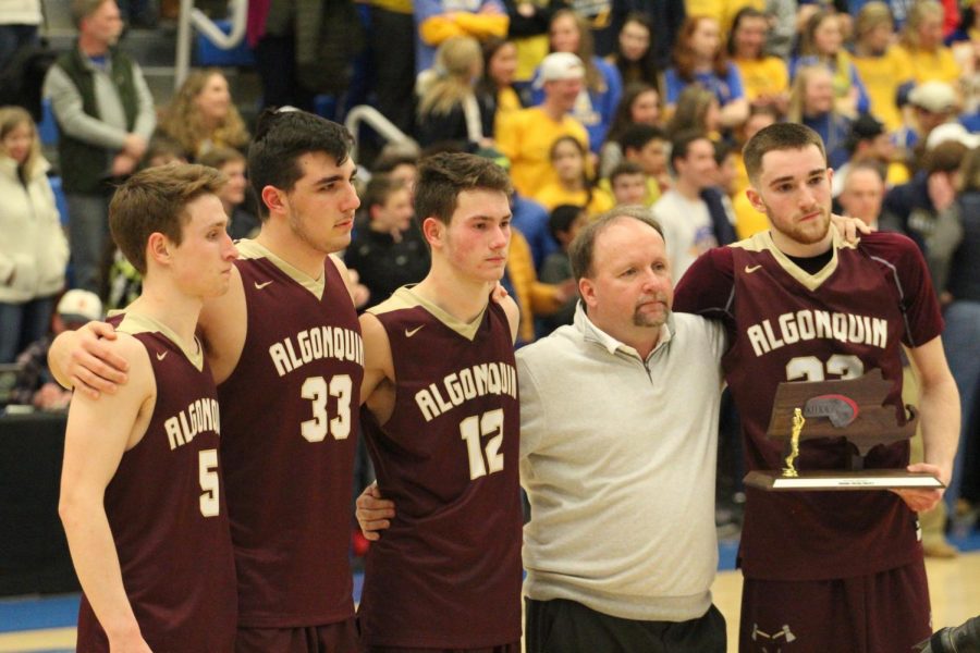 Senior captains (left to right) Brian Duffy, Mike Spataro, Sean Cullen, Nick Redden and coach Brian Doherty posed together after the game. Although they were disappointed by the loss, Doherty is proud of the team.
The seniors that were here this year [photographed] all put Algonquin on the map for basketball, Doherty said. Very rarely do you get as far as we went, and the way we went this year was just fantastic.