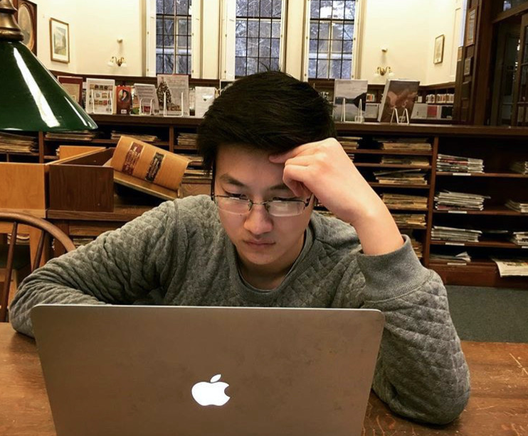 Junior Joe Zhang works on a new article for his website Business With Stories. 
