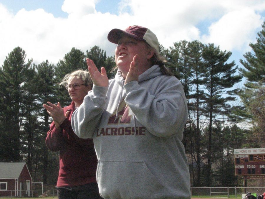 Class of 2013 graduate Emma Decker and new girls lacrosse coach cheers on the team after they score a goal on Dover-Sherborn on April 27.