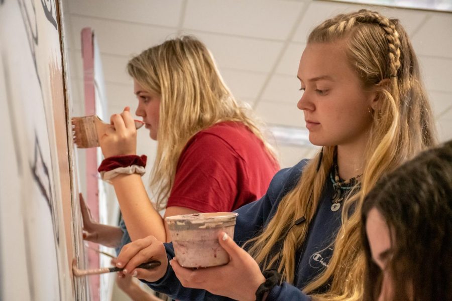 As the spring art show approaches, freshman Colleen Mulligan and sophomore Lauren Decker focus intently to finish their art work.