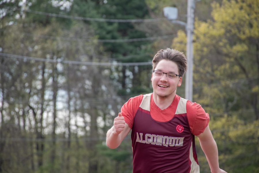 Senior Nick Vaskas runs along the track in the unified track meet against Westborough. 