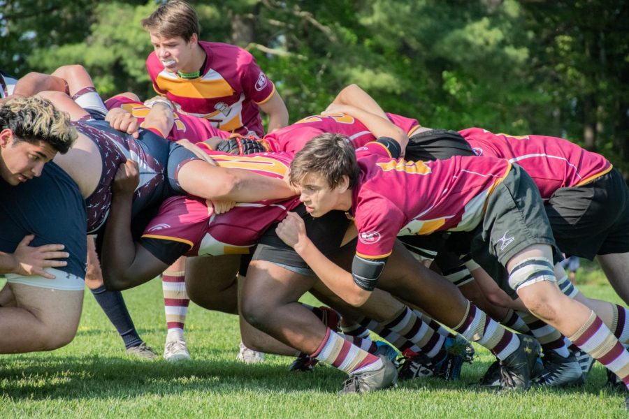 Sophomore Jeff Valentine and freshman Nick McEvoy participate in a scrum, the group that attempts to get the ball at the beginning of a game. The boys rugby team ended up losing to Belmont 69-7.  