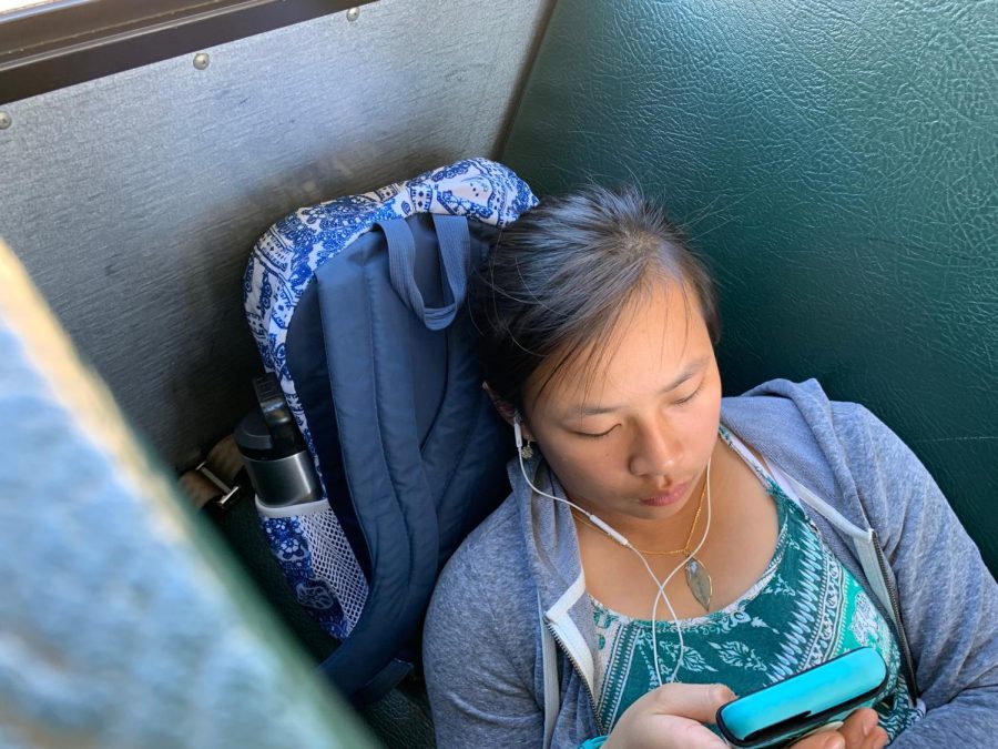 While waiting to get home, freshman Leona Sungkharom reclined on the school bus seat. “Normally on the bus I just read and listen to music, Sungkharom said. Sometimes I’ll talk with my friends.