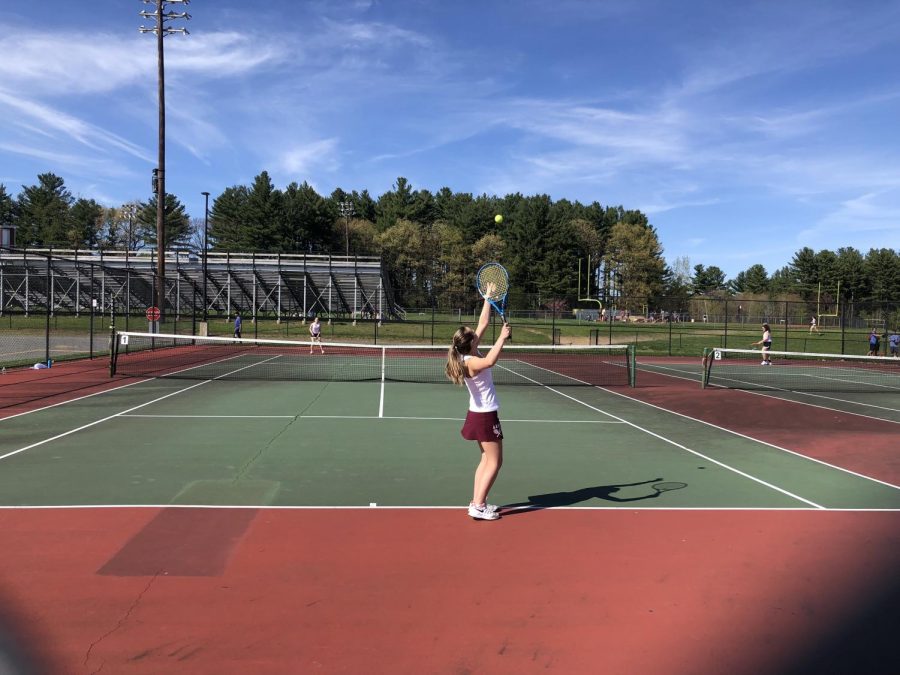 Freshman Olivia Almy delivers a dynamic serve against Marlborough opponent Marissa Petty in the first singles tennis match on May 6. 