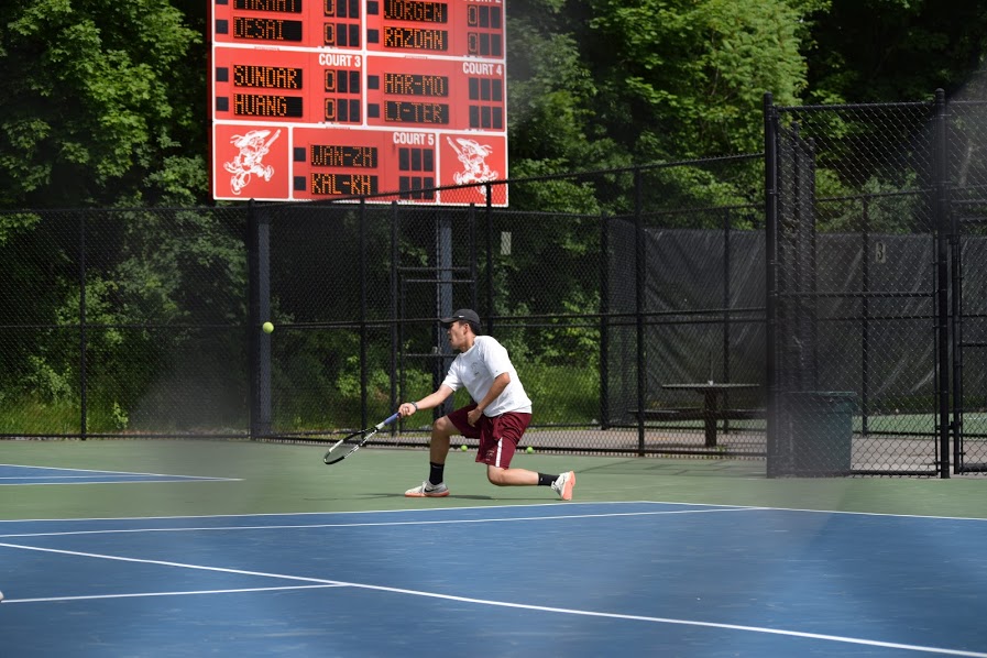 Senior Christopher Wang reaches for the ball in his match in the Central Mass title game on June 10.  Wang and his partner freshman Ethan Zhang won their match 2-1.  