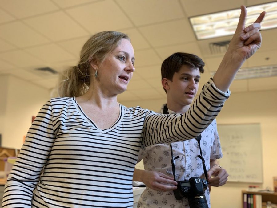 Considering the composition and shape of every article and photo is extremely important when creating a newspaper. On the left, English teacher and adviser Lindsay Coppens instructs senior and Photo Editor Jonny Ratner on how to take a last-minute photo of girls’ tennis to ensure that it fits on the page.
