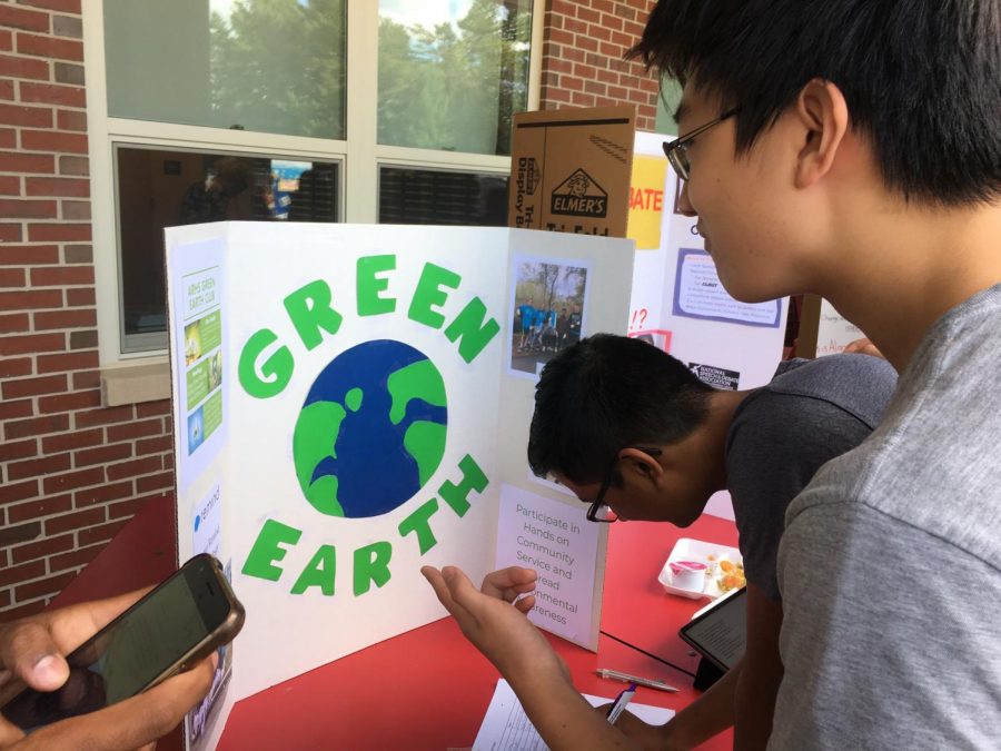 Senior Joe Zhang looks on as senior Tejas Maraliga signs up for The Green Earth Club. Were helping the environment and doing community service in a fun and relaxed manner, vice president and junior Bharathan Sundar said.