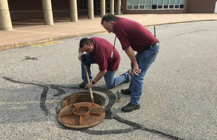 Custodian Norberto Chaves [left] and Director of Facilities Michael Gorman [right] work to fix a blockage on Sept. 4.