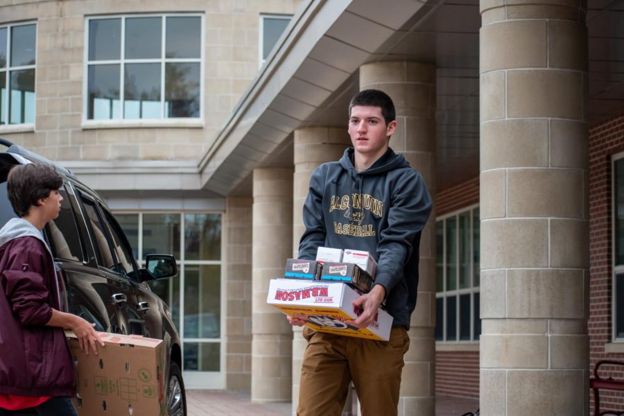 Senior Sam Slovin helps load food at the end of the October food drive. This year, student council led a fall food drive because there was no food at the Northborough Food Pantry.