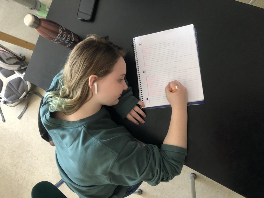 In AP Environmental Science, senior Caroline Ransden rests her head on her arm after writing for a long period of time.