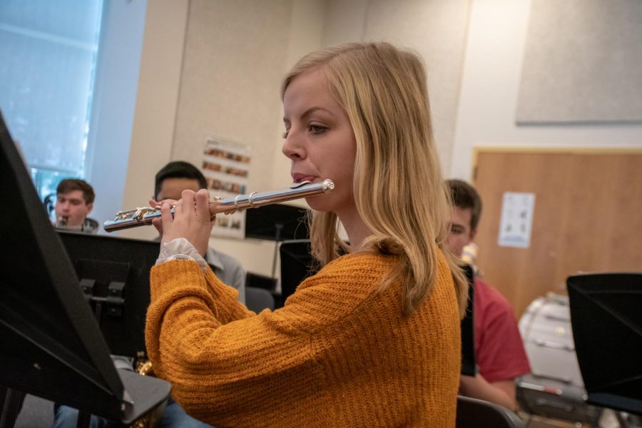 Senior Abby McCue plays her flute as a part of the wind ensemble. For the fall concert, McCue composed an original piece for the ensemble to play.