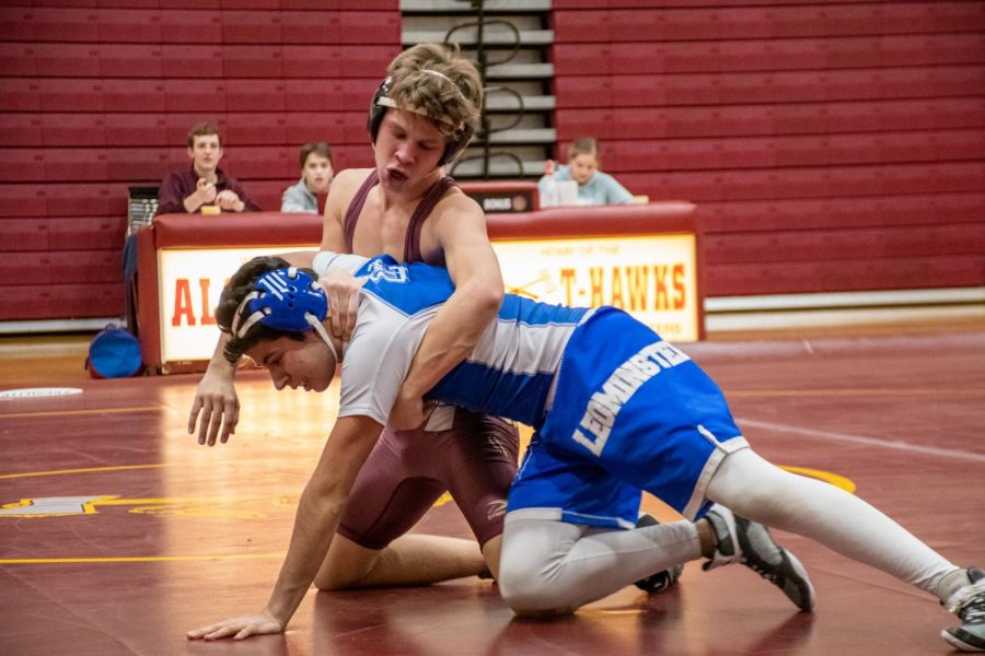 Freshman Cole Friedrich performs a Half Nelson to flip his opponent on his back.