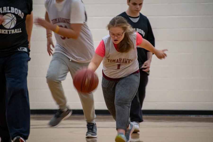Staff Writer Sofia Roumiantsev dribbles the ball in a unified basketball game on Oct. 22. In her opinion, Roumiantsev asserts sports have not only helped her physically, but they have also helped her develop bonds with her peers.