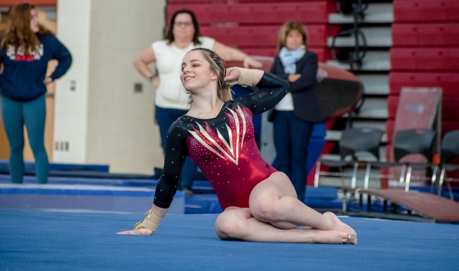 During her floor routine, sophomore Lizzy Debroczy poses for the judges. Algonquin placed first overall at Sectionals.