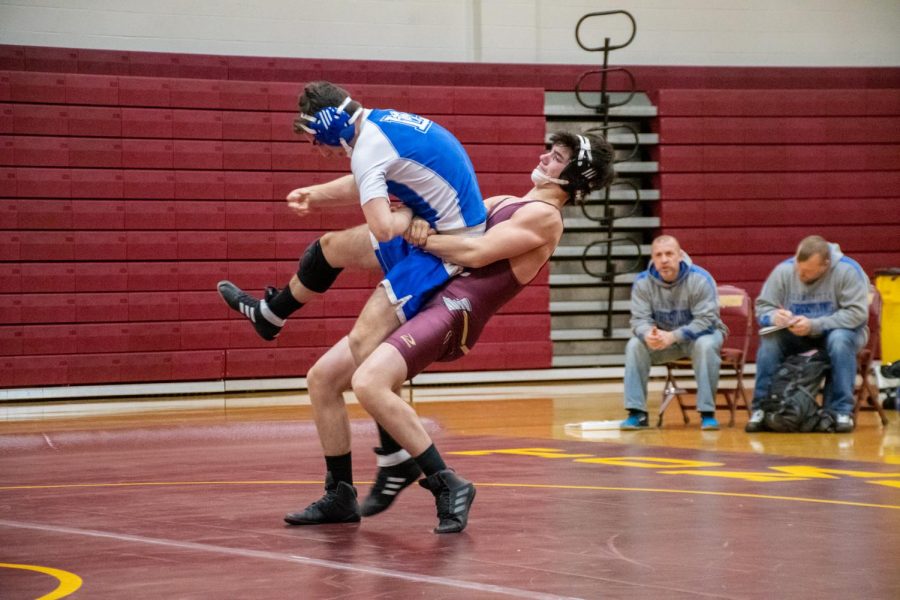 Performing a mat return, junior Jason Vanni lifts his opponent. Vanni added to the teams score to defeat Leominster 48-12.