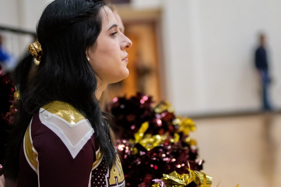 At the beginning of the boys basketball game on Jan. 31, senior Meredith Lapidas looks out with the rest of the cheerleaders.