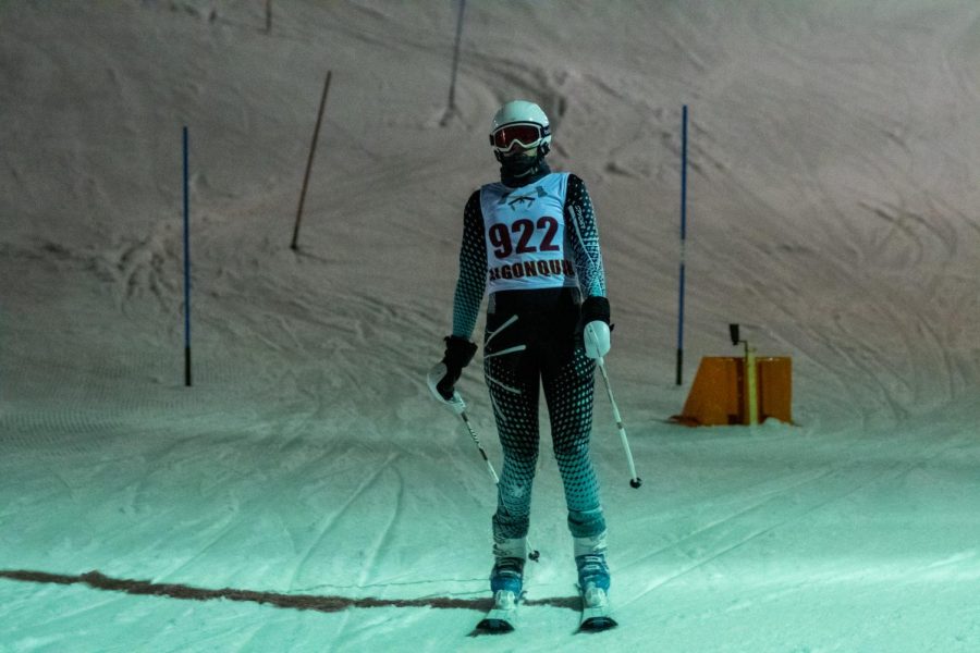 As she finishes her run, senior Hannah Grimm begins to slow down in a meet against multiple other schools at Ski Ward on Feb. 6. Girls’ ski remained undefeated and finished the season with a record of 32-0.