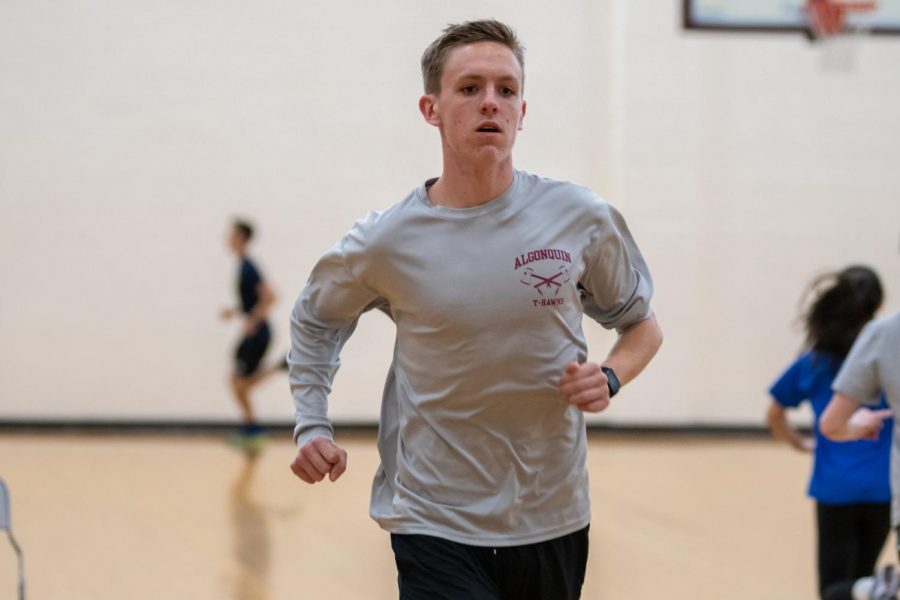 Senior Quinn Potter warms up at practice on Feb. 10. At a meet on Jan. 26, Potter ran the two mile race with a time of 9:55.93, breaking the existing school record.