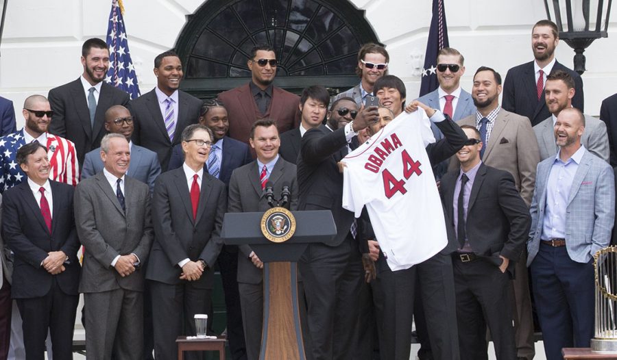 David Ortiz takes a selfie with President Barack Obama as the President is presented with a team jersey during an event to welcome the Boston Red Sox to the White House to honor the team and their 2013 World Series Championship, on the South Lawn of the White House, April 1, 2014. This event also including a speech from Ortiz about the Boston Marathon Bombing. Photo Editor Jonny Ratner writes that sports (or the lack of sports) can bring people together in a unique way.