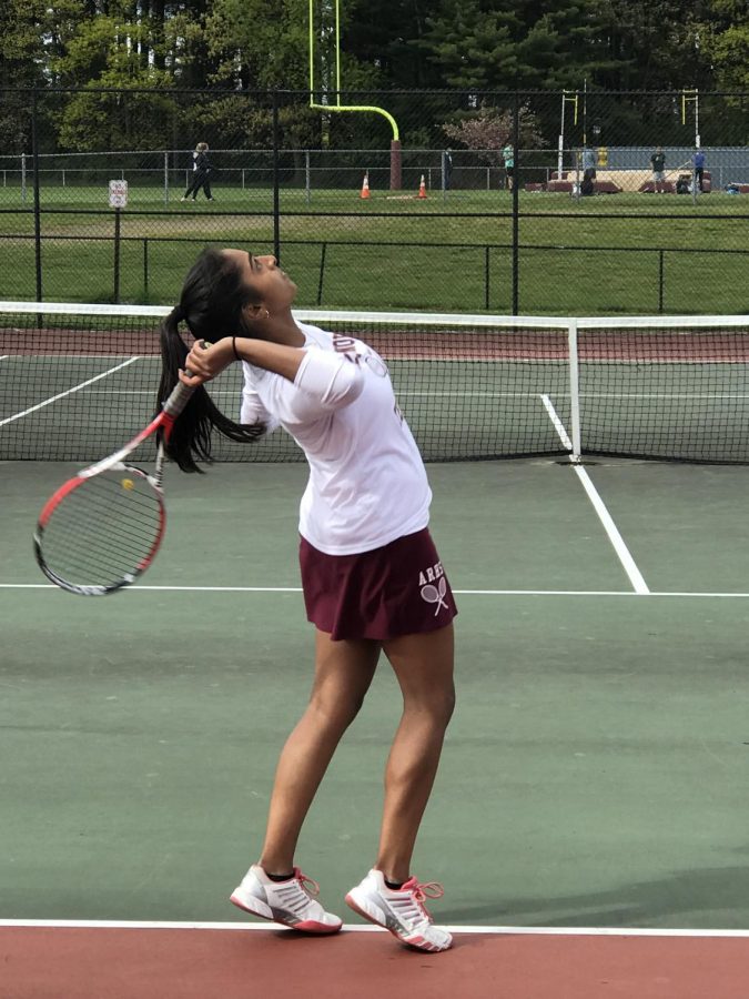 As she begins to swing overhead, senior Ruchitha Rajaghatta keeps her eye on the ball.