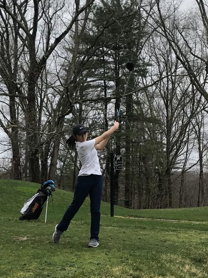 Senior Grace Tang swings her club at a golf match.