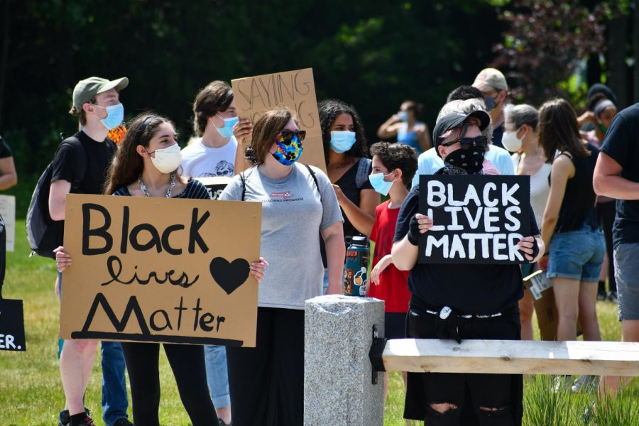 Gatherers in the Northborough Town Common hold up signs and advocate for the Black Lives Matter movement in a protest organized by juniors. 