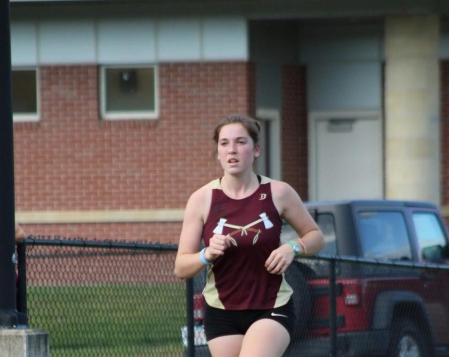 As+she+looks+at+the+runners+ahead+of+her%2C+senior+Allison+Subat+finds+a+comfortable+pace+at+a+cross+country+meet+last+season.
