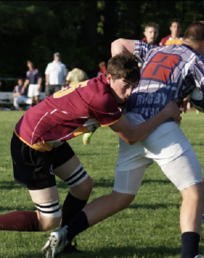 Senior Matthew Webster tackles his opponent from behind.