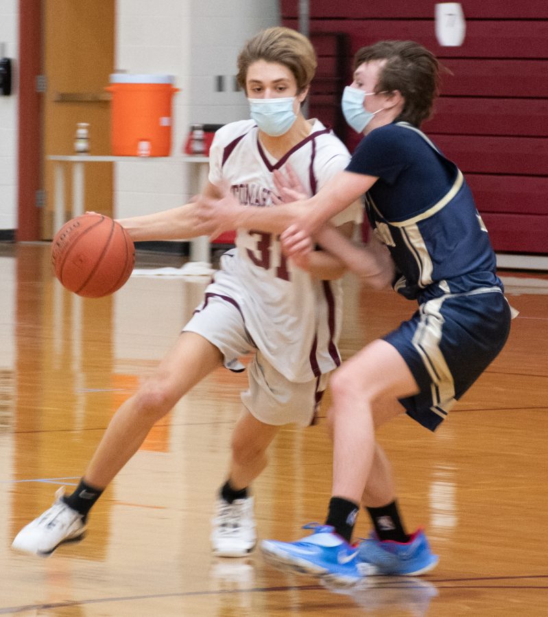Freshman Andrew Eiben tries to dribble around a defender during the JV2 basketball game against Shrewsbury on January 22.