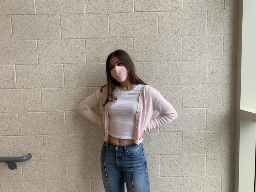 Senior Jenny Lambert pairs her pastel pink sweater with her pastel pink mask. In addition, the laces on her shoes also have a pop of pink, pulling the whole outfit together. 
