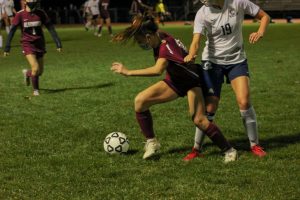 Junior Serena Mihalek pushes her way towards the ball despite the uncalled shirt tug penalty by her Westborough opponent. Westborough put up a good fight against Algonquin however, it was not good enough as Algonquin took the title of Pod 8 champions on November 12.