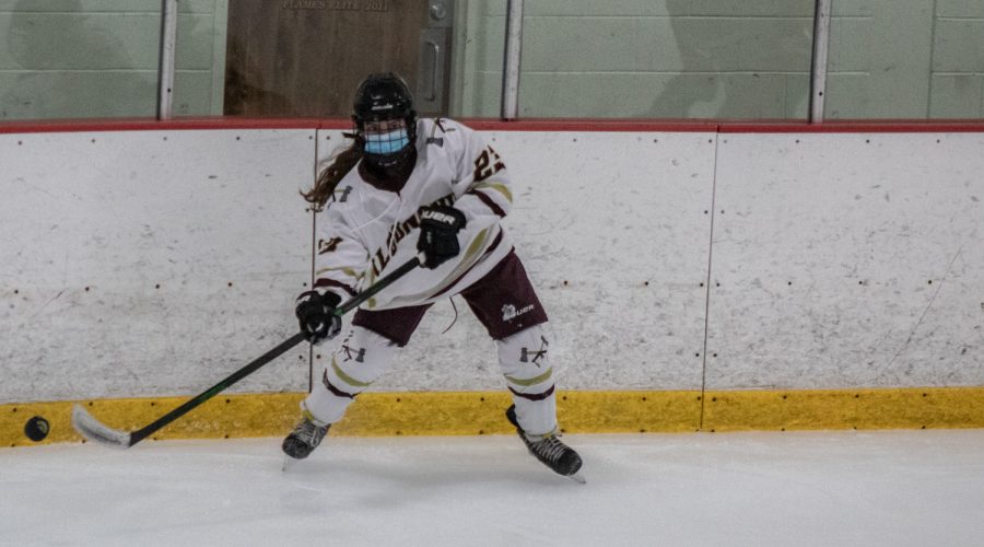Freshman Emily Johns passes the puck to a teammate.