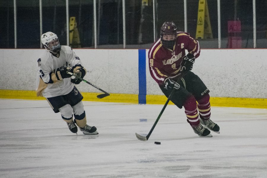 Senior captain Jack Shemligian forwards the puck toward Shrewsbury’s goal in an attempt to score while an opposing defender tries to steal the puck during the January 16 game.