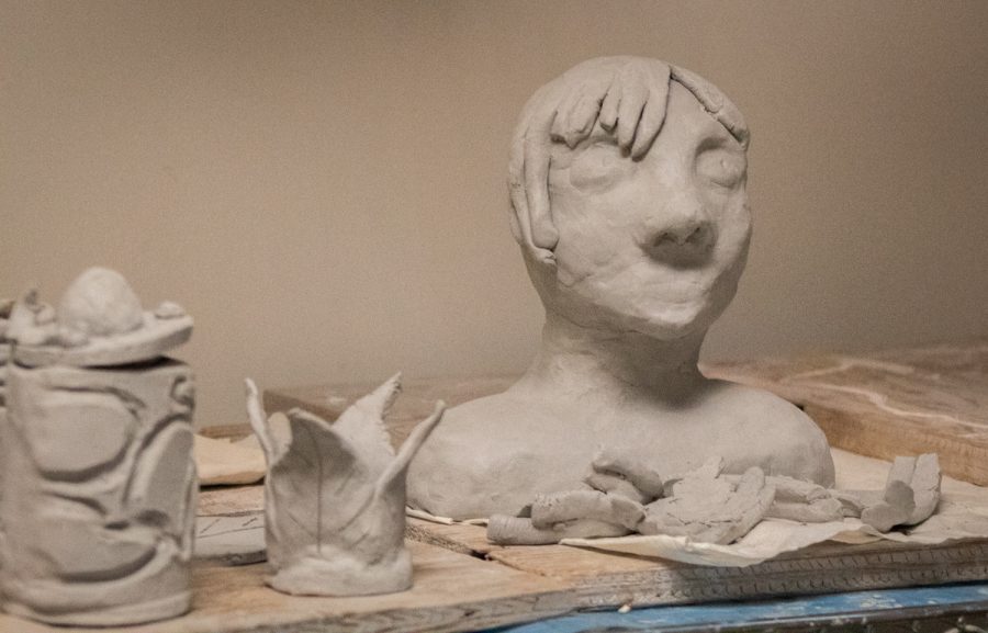 Students make art work out of clay in Ceramics class.