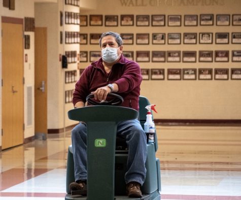 Custodian Armando Bairos cleans the gym lobby. Throughout the evening Armando oversees the school cleaning contractors along with events held at Algonquin.