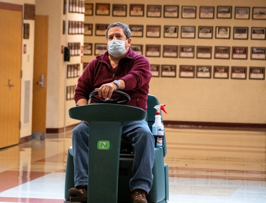 Custodian Armando Bairos cleans the gym lobby. Throughout the evening Armando oversees the school cleaning contractors along with events held at Algonquin.