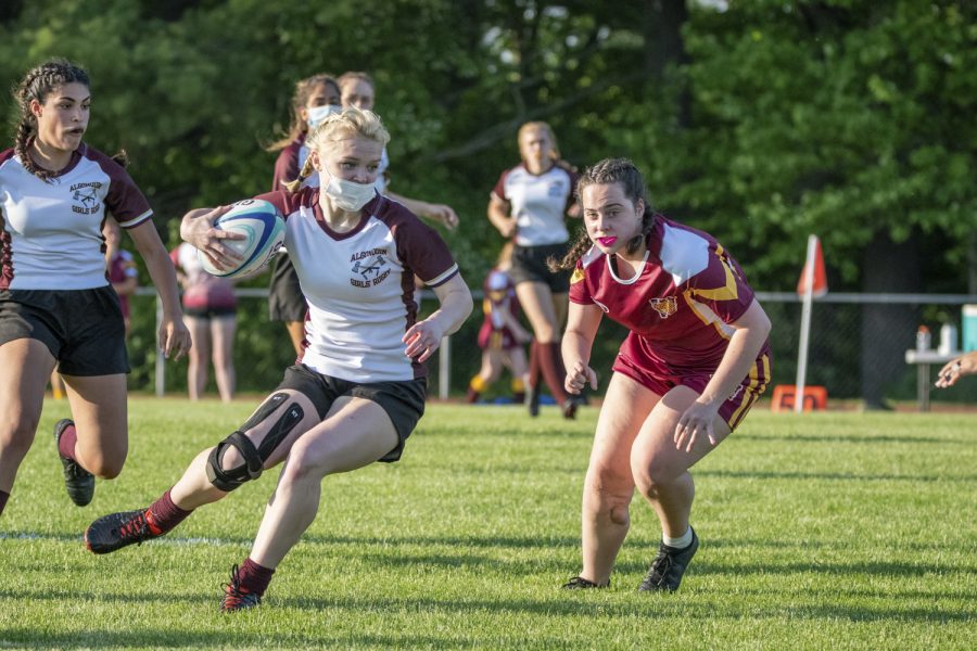 Junior Colleen Mulligan running to the opponents side of the field in order to get a try, which is a way to score points in the sport. The girls rugby team ended up winning against Weymouth 14-10.