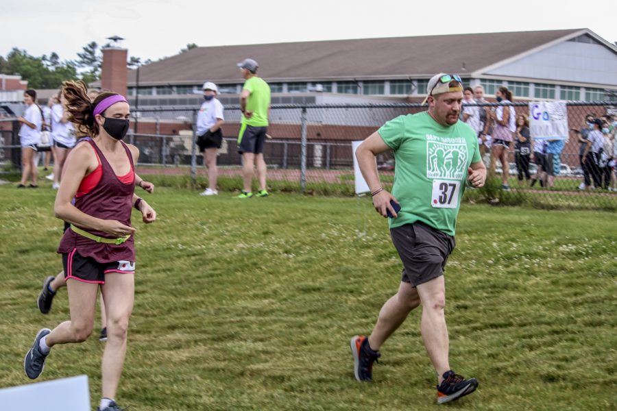 After being let out in groups, school nurse Erika Almquist and science teacher Kevin Hausmann run the 5k fundraiser in support for autism awareness. The 5k was planned by Chick-Fil-A leadership academy students.