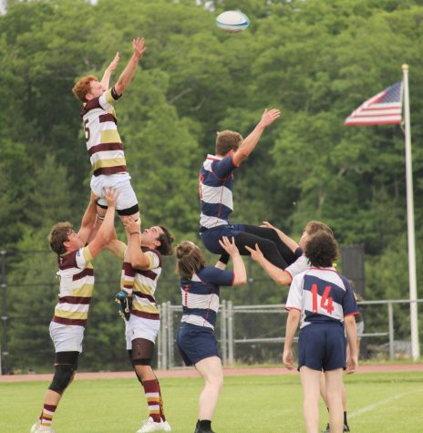 Two Algonquin rugby players lift their teammate, Edward Gostick, in a lineout in order to get the ball during the boys rugby game against Brookline on June 3rd. 