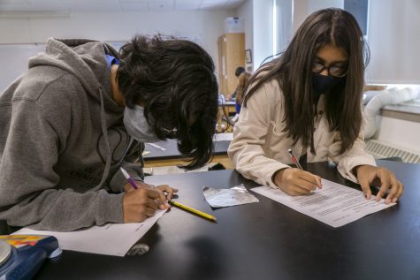 Sophomores Abhaya Sundar and Lipi Niyogi work on their lab during their Chemistry class.