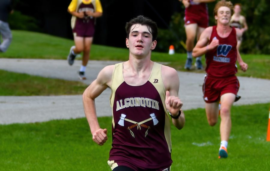 Sprinting to the finish line, sophomore Joe Lamburn looks ahead as he finishes his third lap. 