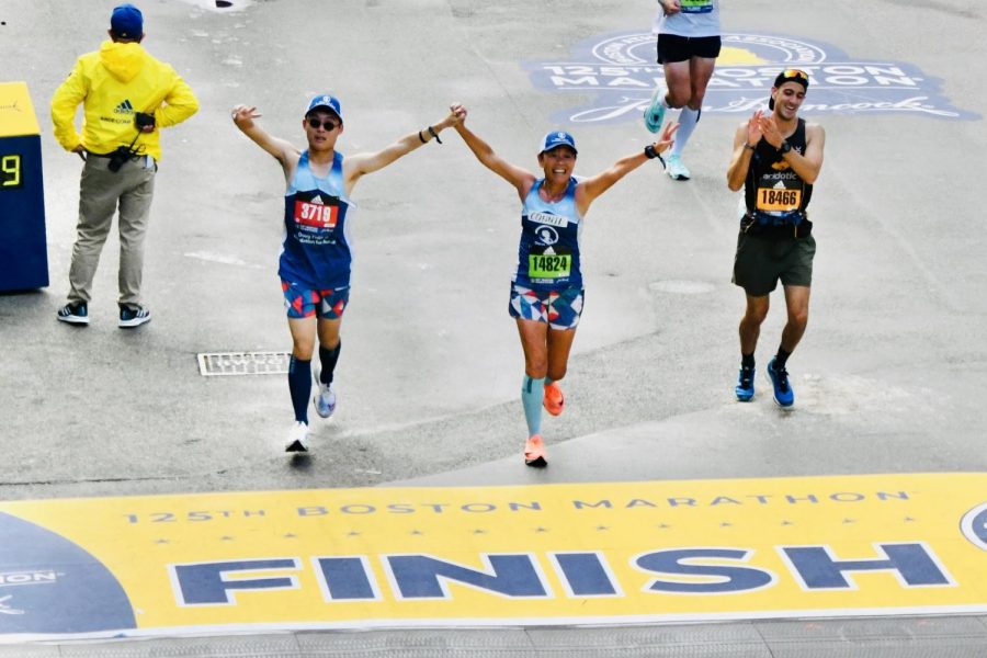 Senior+Enchee+Xu+and+his+mother%2C+Connie+Cao%2C+triumphantly+cross+the+finish+line%2C+hand-in-hand%2C+after+running+the+entire+Boston+Marathon+together.